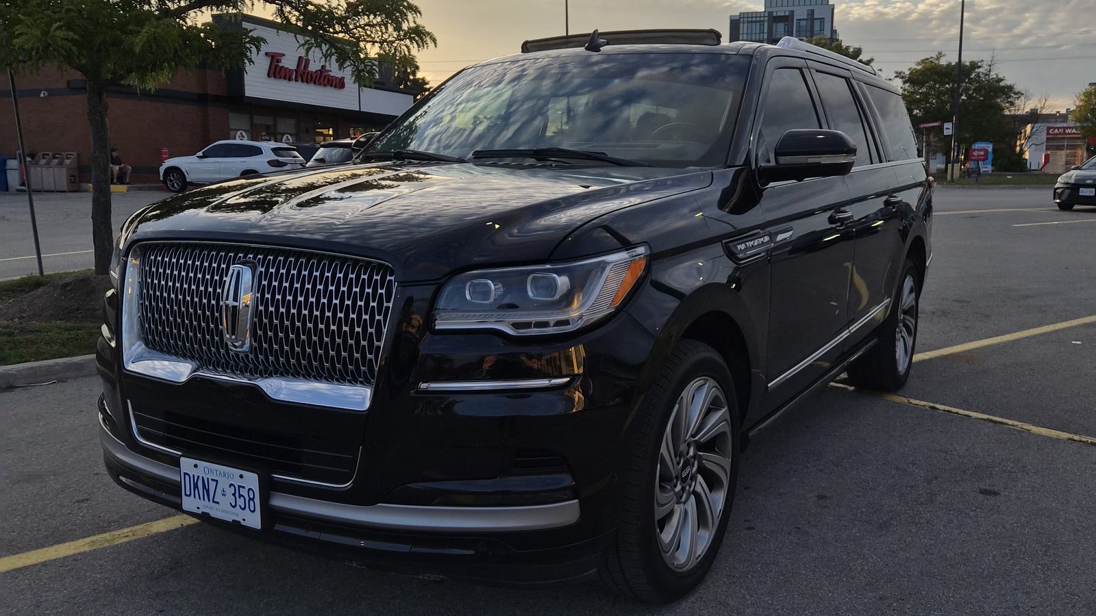 Crown & Coach's black 2022 Lincoln Navigator L, photographed at dusk in Ottawa, three-quarter front view.